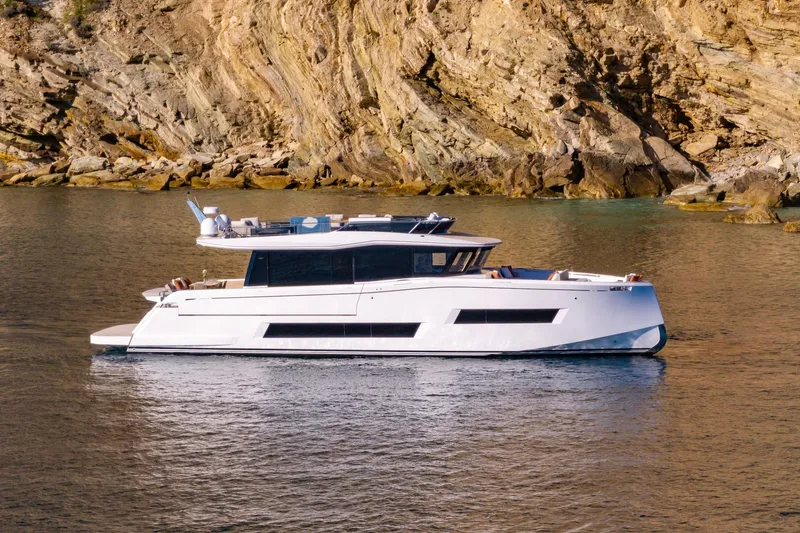  Yacht Photos Pics Luxury 2026 Pardo Yachts E72 cruising near rocky coastline.