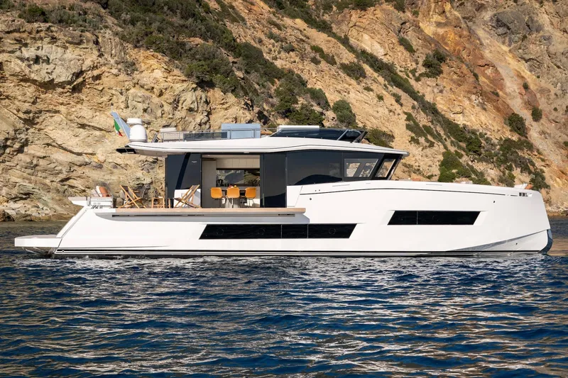  Yacht Photos Pics 2026 Pardo Yachts E72 luxury yacht cruising near rocky coastline.