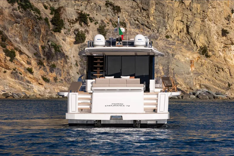  Yacht Photos Pics 2026 Pardo Yachts E72 luxury yacht cruising near rocky coastline.