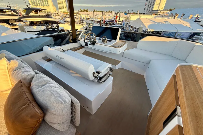  Yacht Photos Pics Luxurious 2026 Pardo Yachts E72 interior with modern helm and plush seating at a marina.