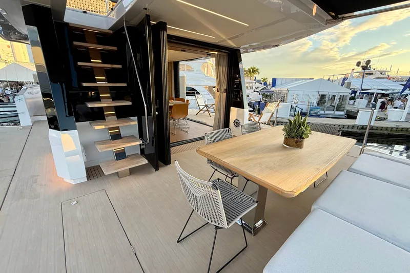  Yacht Photos Pics Outdoor deck of 2026 Pardo Yachts E72 with dining table and modern staircase.