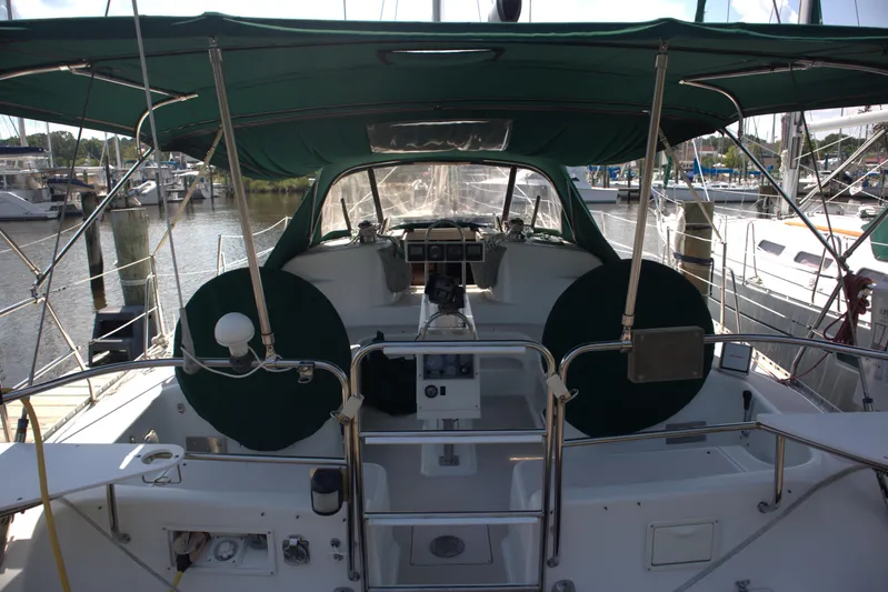 Immunity Yacht Photos Pics 1996 Catalina 400 sailboat cockpit with green canopy, docked at marina.