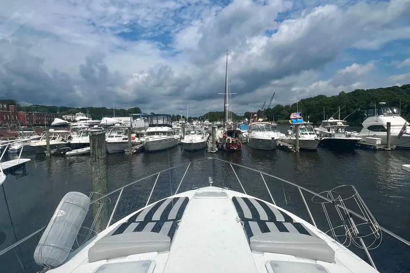 Talitoo Yacht Photos Pics 2006 Formula 37 PC yacht docked in a bustling marina under a partly cloudy sky.