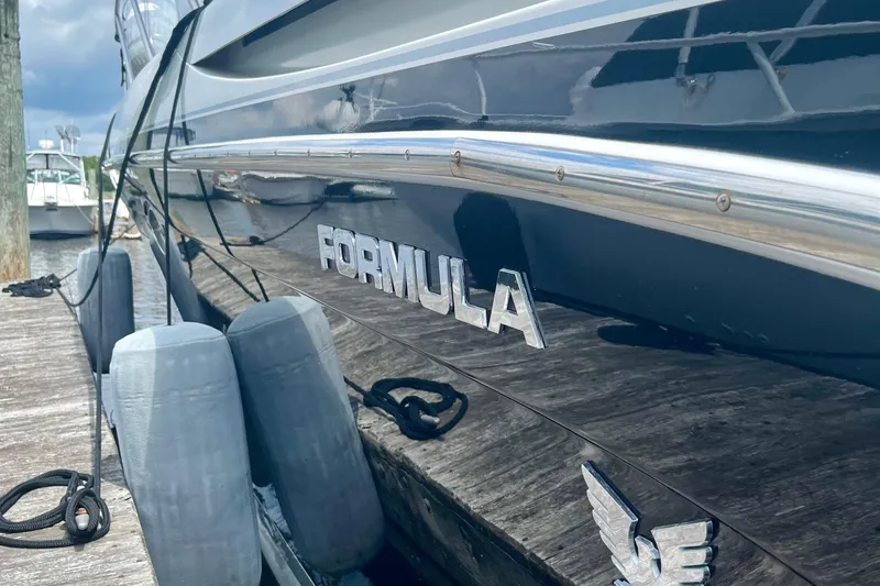 Talitoo Yacht Photos Pics 2006 Formula 37 PC yacht docked with visible logo and fenders.