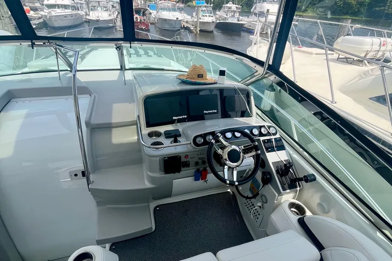 Talitoo Yacht Photos Pics 2006 Formula 37 PC yacht helm with modern controls, docked among other boats.