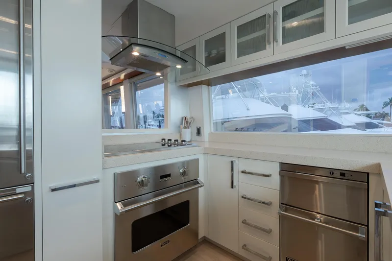 Whistle Yacht Photos Pics Modern kitchen interior on 2012 Lazzara Breeze yacht, featuring sleek appliances and large windows.