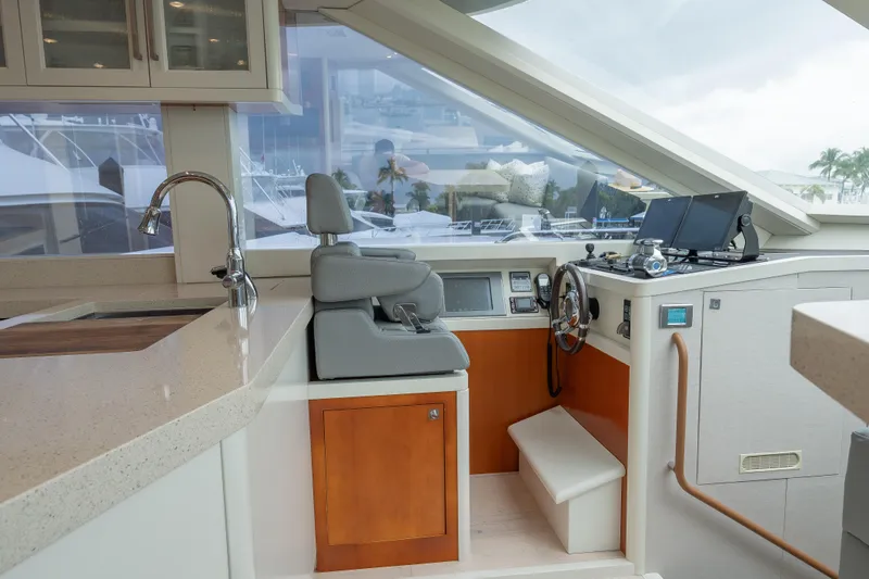 Whistle Yacht Photos Pics 2012 Lazzara Breeze yacht interior with helm, modern kitchen, and navigation equipment.