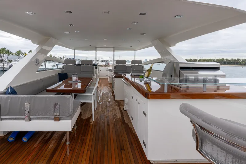 Whistle Yacht Photos Pics Luxurious 2012 Lazzara Breeze yacht deck with seating, dining area, and grill.