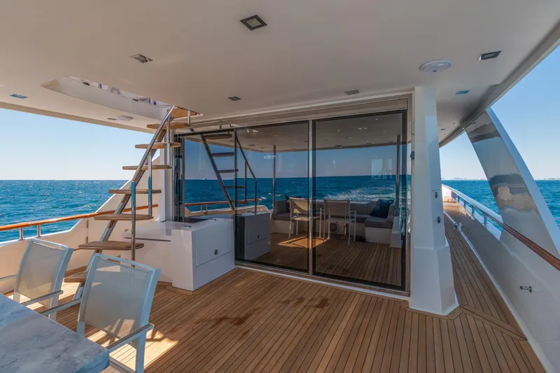 Whistle Yacht Photos Pics Luxurious 2012 Lazzara Breeze yacht deck with ocean view, featuring elegant seating and wooden flooring.