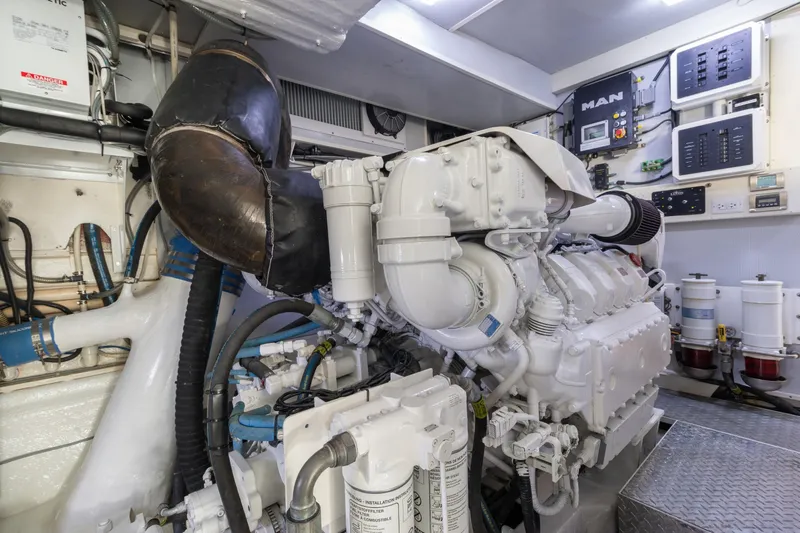 Whistle Yacht Photos Pics Engine room of a 2012 Lazzara Breeze yacht, featuring complex machinery and control panels.