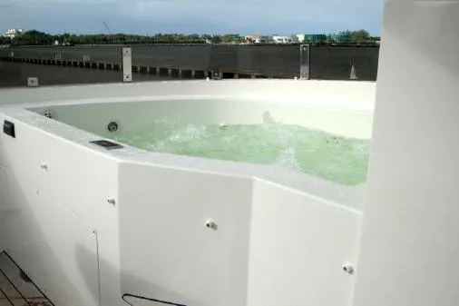 Whistle Yacht Photos Pics Luxurious hot tub on 2012 Lazzara Breeze yacht deck, with bubbling water and scenic view.