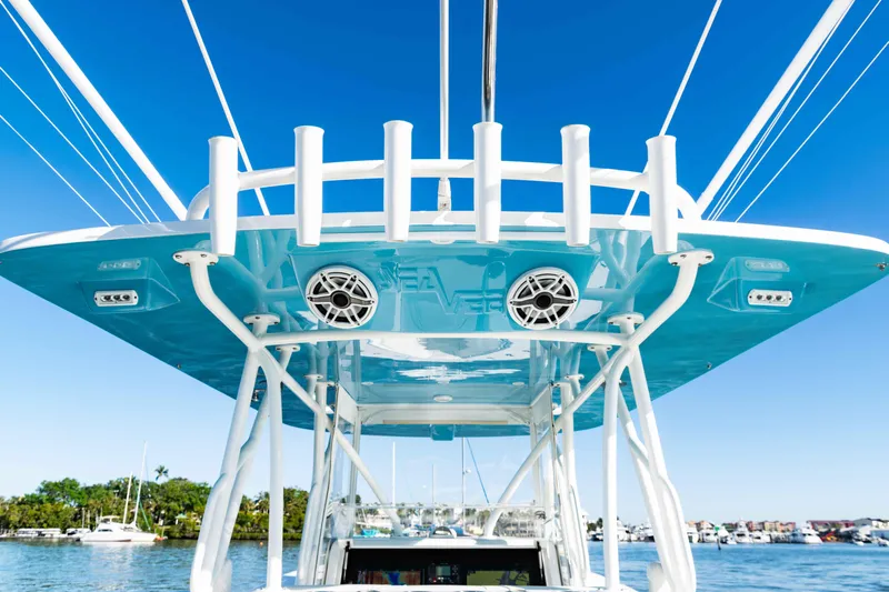  Yacht Photos Pics 2020 SeaVee 370z boat with blue canopy and rod holders, docked in a marina.