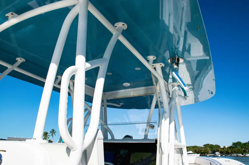  Yacht Photos Pics 2020 SeaVee 370z boat with blue canopy and white framework under clear sky.