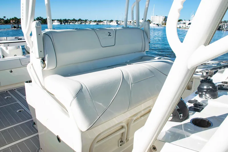  Yacht Photos Pics 2020 SeaVee 370z boat with white cushioned seating, docked by a marina.