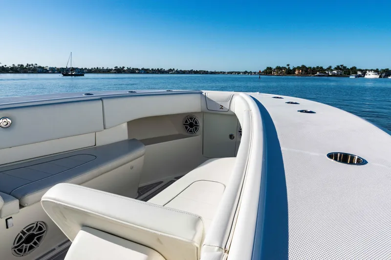 Yacht Photos Pics 2020 SeaVee 370z boat interior with white seating, on calm water under clear blue sky.