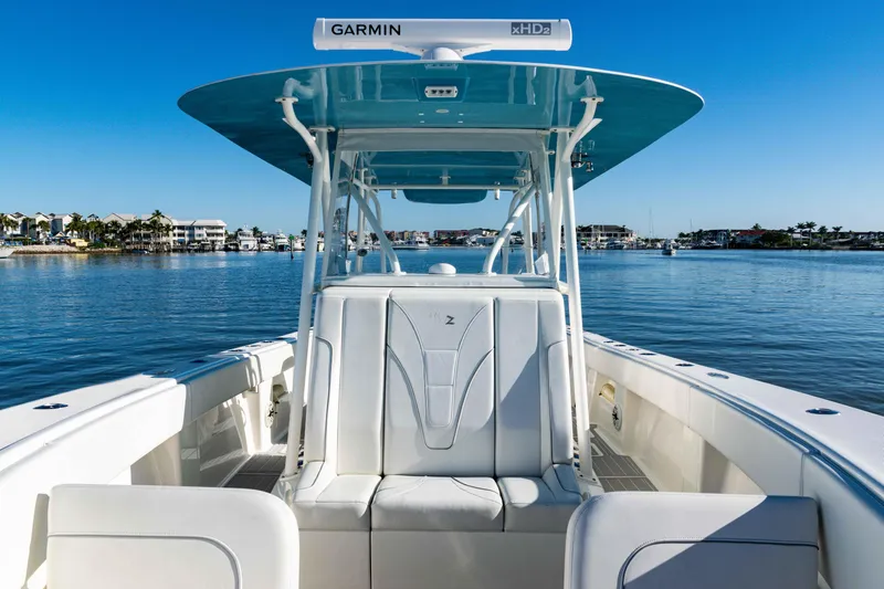  Yacht Photos Pics 2020 SeaVee 370z boat with Garmin equipment, docked on calm water under clear blue sky.