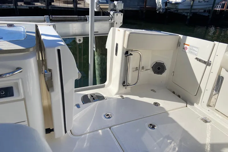  Yacht Photos Pics 2024 Boston Whaler 320 Vantage boat interior with open deck and storage compartments.