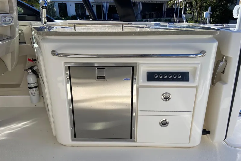  Yacht Photos Pics 2024 Boston Whaler 320 Vantage boat interior with kitchenette and storage compartments.