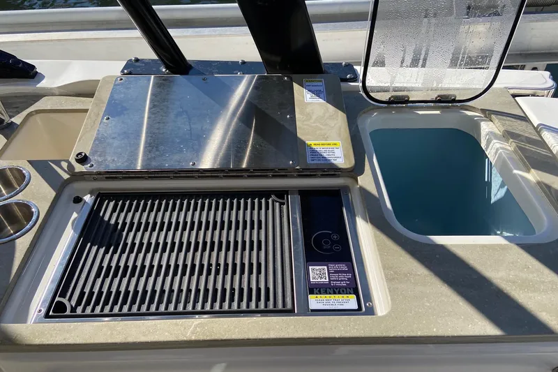  Yacht Photos Pics 2024 Boston Whaler 320 Vantage boat grill and sink setup, featuring Kenyon grill.