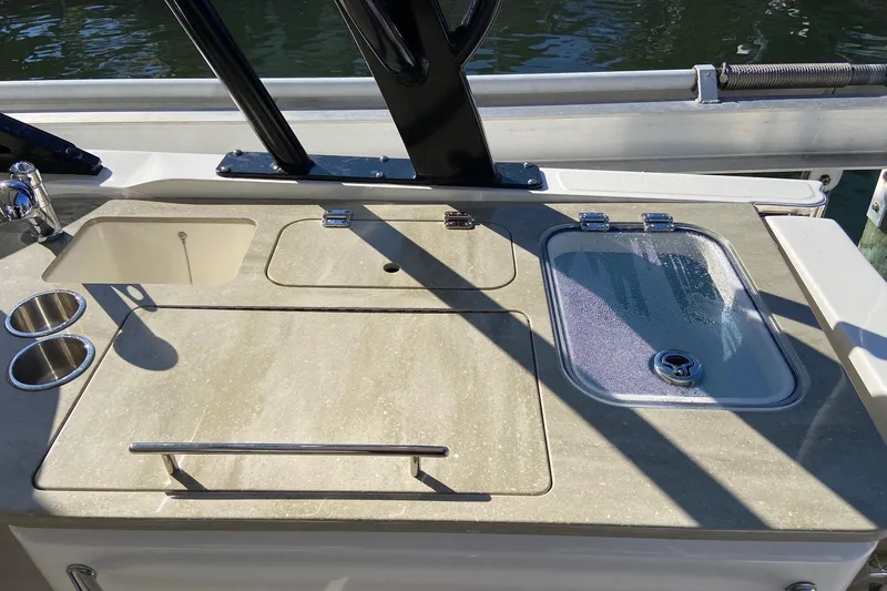 Yacht Photos Pics 2024 Boston Whaler 320 Vantage boat deck with sink and storage compartments.