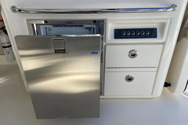  Yacht Photos Pics 2024 Boston Whaler 320 Vantage boat interior with stainless steel fridge and control panel.