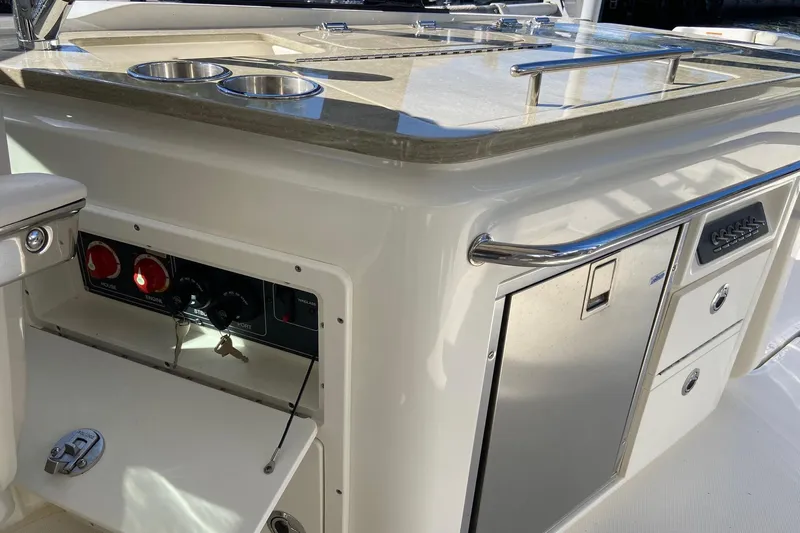  Yacht Photos Pics 2024 Boston Whaler 320 Vantage boat interior with control panel and storage compartments.