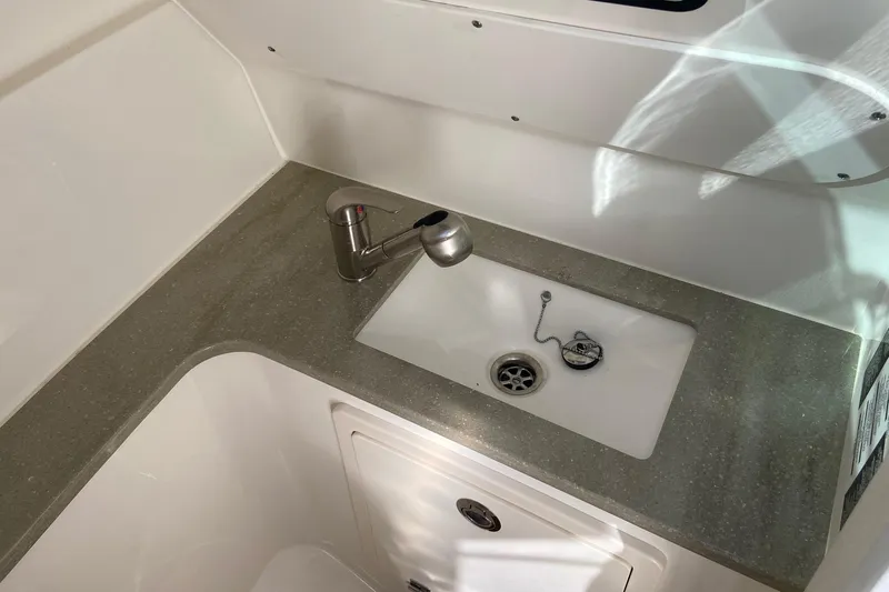  Yacht Photos Pics 2024 Boston Whaler 320 Vantage interior sink with modern faucet and countertop.