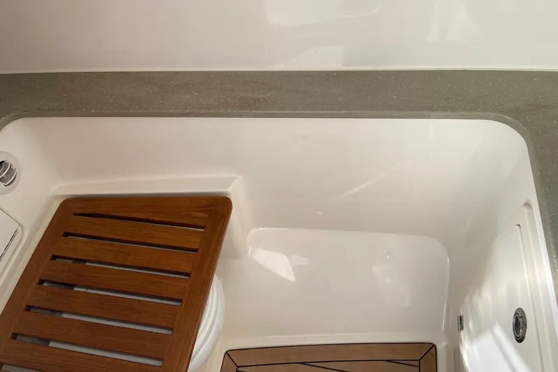  Yacht Photos Pics 2024 Boston Whaler 320 Vantage interior with wooden accents and sleek design.