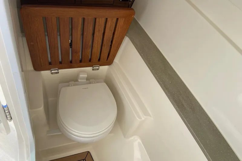  Yacht Photos Pics 2024 Boston Whaler 320 Vantage boat interior with compact marine toilet.