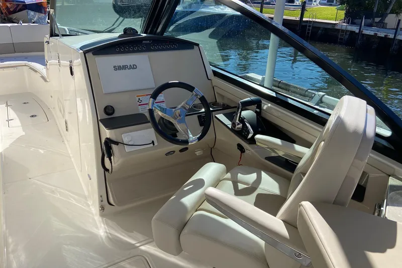  Yacht Photos Pics 2024 Boston Whaler 320 Vantage helm with Simrad display, luxurious seating, and modern controls.
