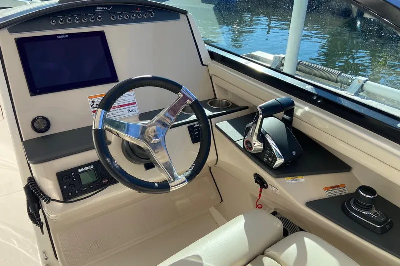  Yacht Photos Pics 2024 Boston Whaler 320 Vantage helm with steering wheel and control panel.