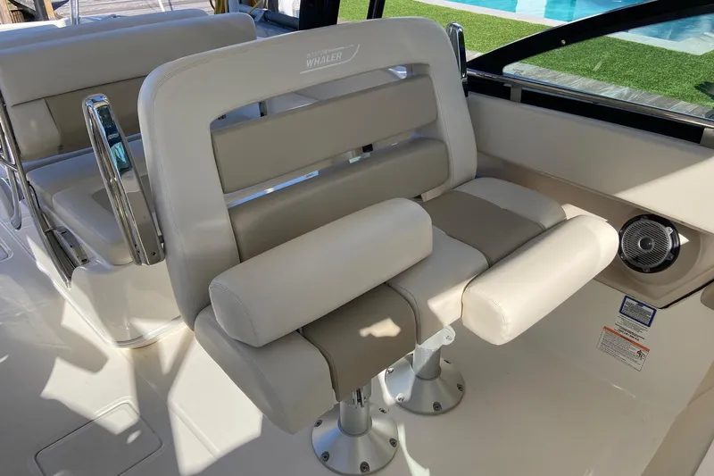  Yacht Photos Pics 2024 Boston Whaler 320 Vantage boat interior with beige seating and chrome accents.