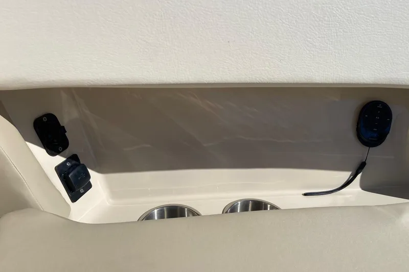  Yacht Photos Pics 2024 Boston Whaler 320 Vantage interior detail with cup holders and control panel.