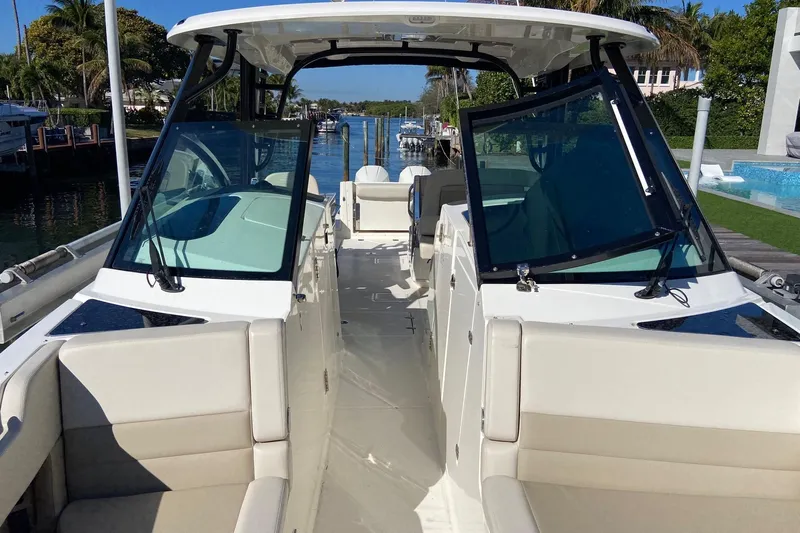  Yacht Photos Pics 2024 Boston Whaler 320 Vantage boat interior with seating and open deck view.