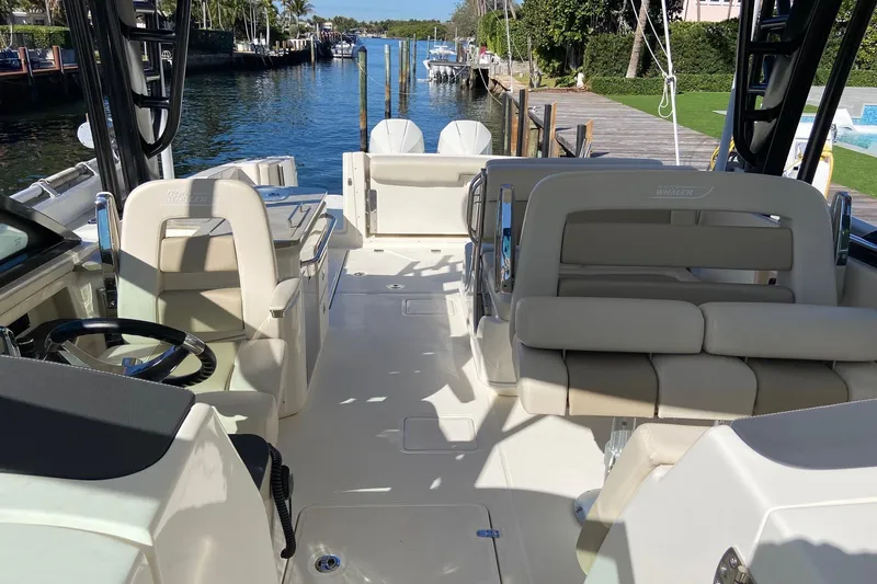  Yacht Photos Pics 2024 Boston Whaler 320 Vantage boat interior with luxurious seating and steering wheel.