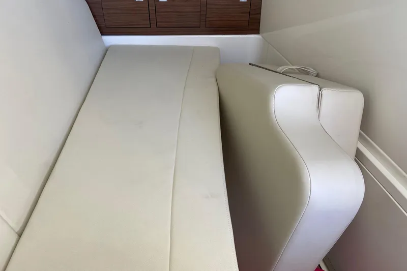  Yacht Photos Pics 2024 Boston Whaler 320 Vantage interior seating with beige upholstery and wooden accents.