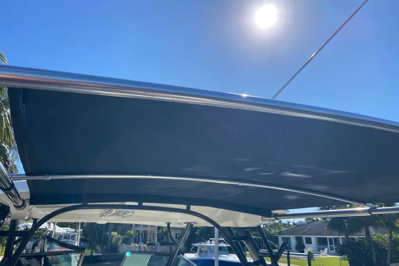  Yacht Photos Pics 2024 Boston Whaler 320 Vantage boat canopy under sunny sky.
