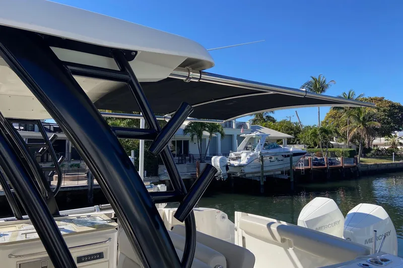  Yacht Photos Pics 2024 Boston Whaler 320 Vantage boat docked, featuring sleek design and Mercury engines.