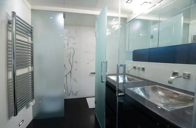  Yacht Photos Pics Luxurious yacht bathroom with modern fixtures, frosted glass, and dual sinks. Admiral 34m, 2007.