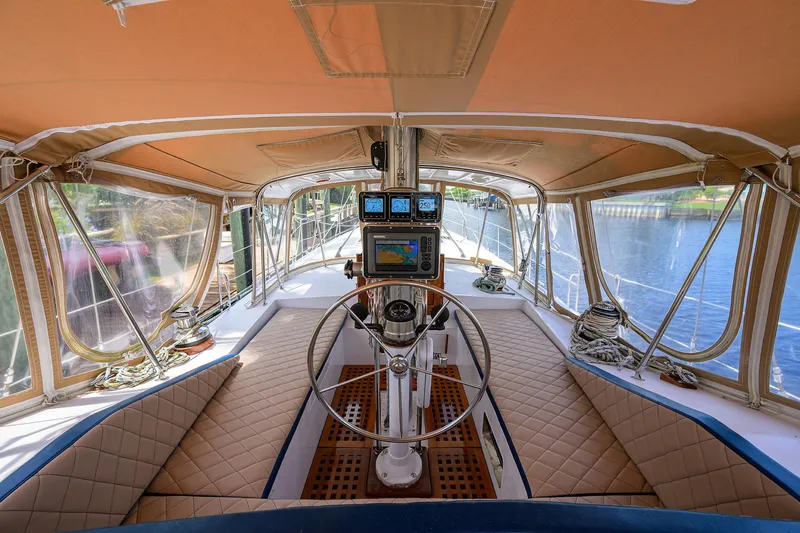 Running On Empty Yacht Photos Pics Cockpit of 2013 Custom 46 Dennis Schreibert Schooner with navigation equipment and cushioned seating.