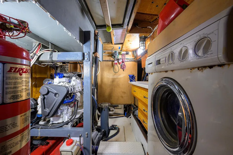 Running On Empty Yacht Photos Pics Engine room of 2013 Custom 46 Dennis Schreibert Schooner with washing machine and fire extinguisher.