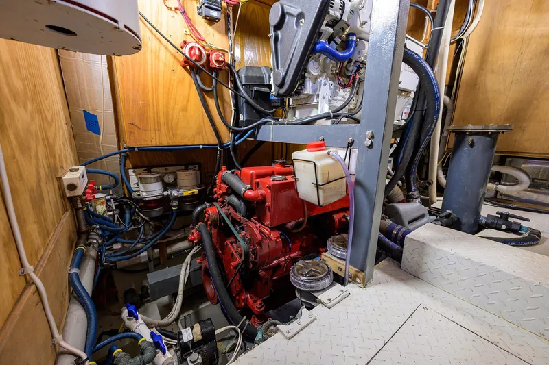 Running On Empty Yacht Photos Pics Engine room of 2013 Custom 46 Dennis Schreibert Schooner with red machinery and piping.