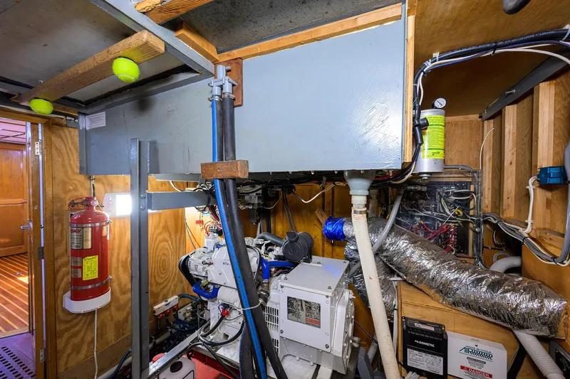 Running On Empty Yacht Photos Pics Engine room of 2013 Custom 46 Dennis Schreibert Schooner with equipment and fire extinguisher.