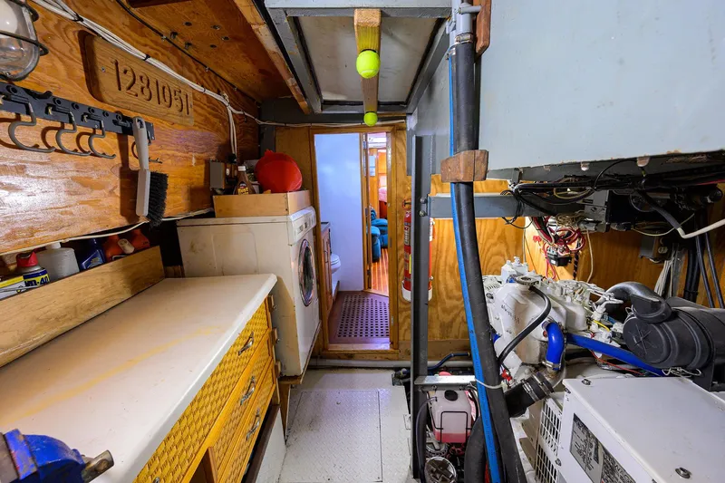 Running On Empty Yacht Photos Pics Interior of 2013 Custom 46 Dennis Schreibert Schooner with laundry area and mechanical equipment.