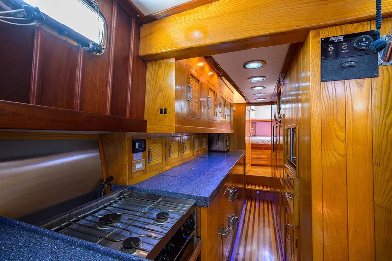 Running On Empty Yacht Photos Pics Luxurious wooden interior of 2013 Custom 46 Dennis Schreibert Schooner with modern kitchen amenities.