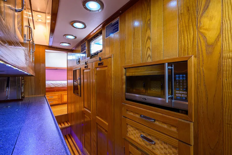 Running On Empty Yacht Photos Pics Luxurious wooden interior of 2013 Custom 46 Dennis Schreibert Schooner with modern amenities.