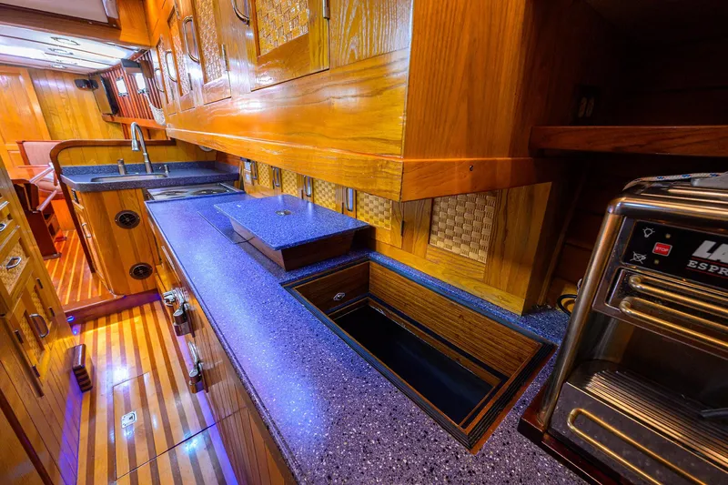 Running On Empty Yacht Photos Pics Luxurious wooden interior of a 2013 Custom 46 Dennis Schreibert Schooner kitchen.