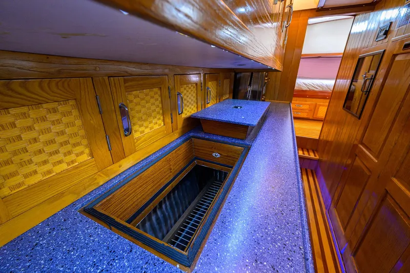 Running On Empty Yacht Photos Pics Luxurious wooden interior of 2013 Custom 46 Dennis Schreibert Schooner with modern countertops.