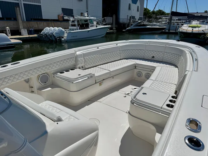  Yacht Photos Pics 2017 Intrepid 375 Center Console boat with spacious seating at a marina.