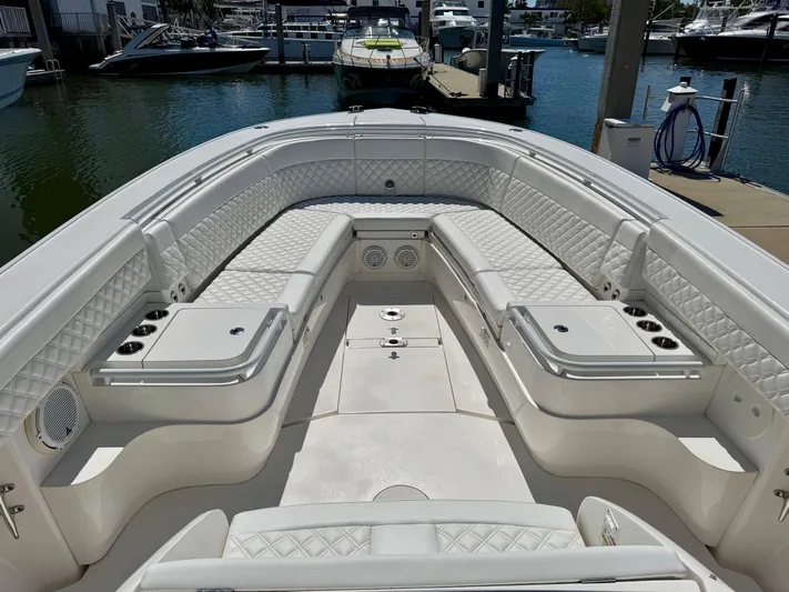  Yacht Photos Pics 2017 Intrepid 375 Center Console boat with luxurious seating and sleek design at a marina.